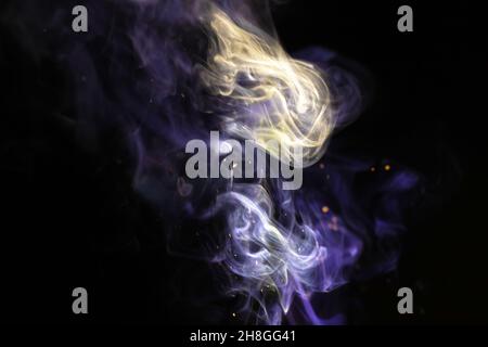 Abstract smoke with sparkles on a black background. Colored fog texture Stock Photo