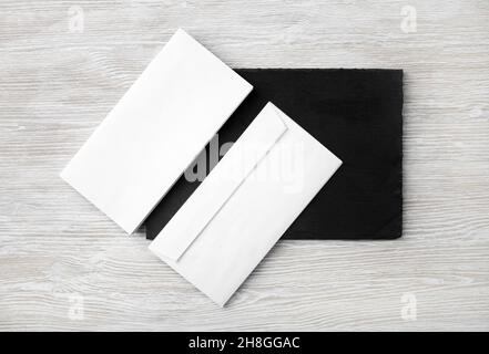 Blank white envelopes on stone board. Copy space. Flat lay. Stock Photo