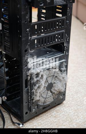 Dust on the computer pc processor cooler with mainboard and computer case fragment. Selective focus. Stock Photo