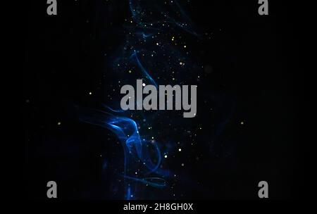 Abstract blue smoke with sparkles on a black background. Colored fog texture Stock Photo
