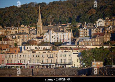 Weston-super-Mare seaside town in Somerset, England. Holy Trinity Weston and the beach waterfront promenade Stock Photo