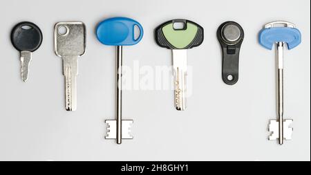 Different metal keys for doors isolated on studio background Stock Photo