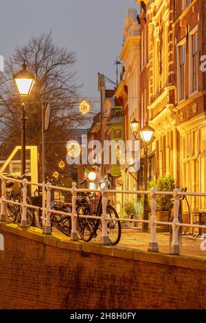 Evening view of an ancient street with christmas decoration in the historic city center of the Dutch city of Alkmaar Stock Photo