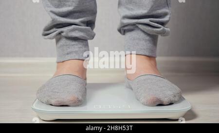 Bare feet stand on smart scales that makes bioelectric impedance analysis,  BIA, body fat measurement. Stock Photo by ©akoldunov 369502604