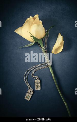 Yellow rose with two necklaces with pendants inscribed Friends and Forever Stock Photo