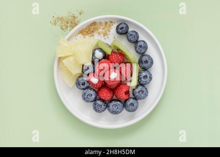 Fresh berries and fruits on white plate with copy space Stock Photo
