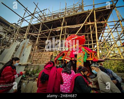 Kathmandu, Bagmati, Nepal. 30th Nov, 2021. People gather to offer prayers to Goddess Guhyeshwari during Guhyeshwari yatra at the palanquin kept in front of the under construction Jagannath temple at Hanumandhoka Durbar Square in Kathmandu, Nepal on November 30, 2021. Guhyeshwari Yatra is a festival, which is a tour that starts carrying palanquin consisting idols from Guhyeshwari following Pashupatinath Temple and ends at Hanuman Dhoka Durbar Square. (Credit Image: © Sunil Sharma/ZUMA Press Wire) Stock Photo