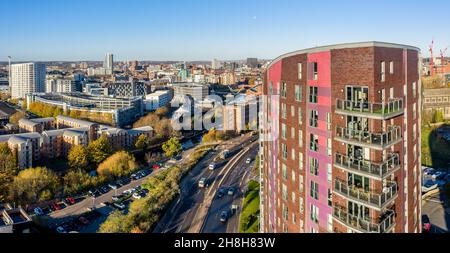 An aerial panorama cityscape of Leeds city with high rise apartment buildings and transport links into the urban sprawl Stock Photo