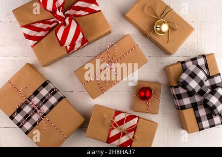 Top view flatlay of Christmas brown craft paper wrapped gift boxes. Stock Photo