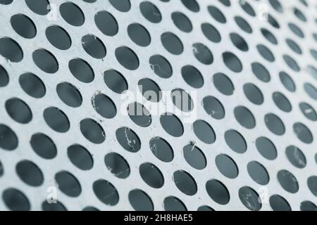 Round-hole grating as a structured background for design. Stock Photo