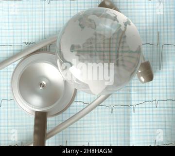 Glass globe and stethoscope over the ECG trace, concept of diagnosis of cardiac diseases. Stock Photo