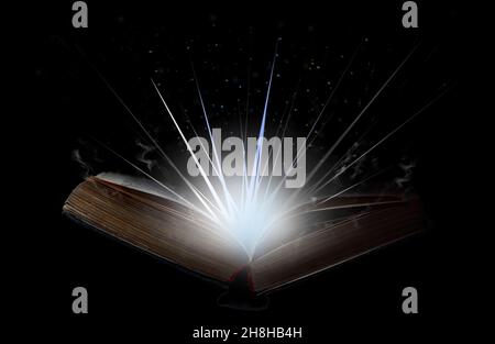 Open book with flash of light, magical smoke and glitter in the air. Stock Photo