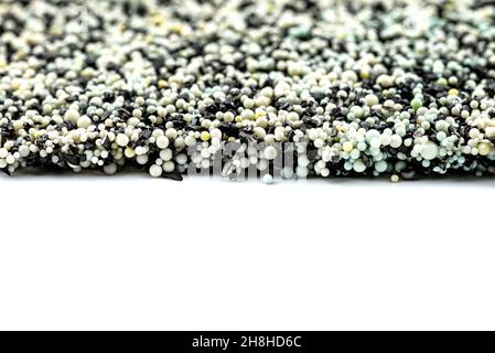 Background made from a macro photo of the inside of the filter with active carbon and water filtration pearls, isolated on a white background. Stock Photo