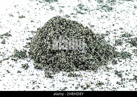 A background made out of a heap inside a filter with activated carbon and water filtration beads, isolated on a white background. Stock Photo