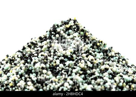 A background made out of a heap inside a filter with activated carbon and water filtration beads, isolated on a white background. Stock Photo
