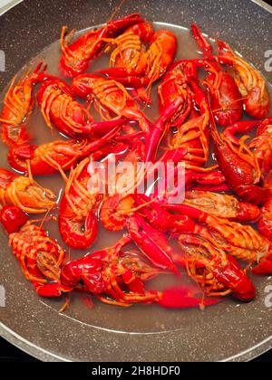 Boiled crawfish on a grey plate. Crawfish resembles and taste like lobsters. It is also known as Crayfish in some areas. Bright-colored crawfish. Seafood. Healthy lifestyle concept. Stock Photo