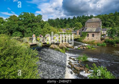 France, Morbihan, La Gacilly, footbridge over the Aff river and Yves Rocher House Stock Photo