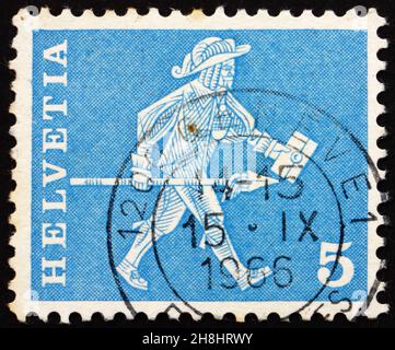 SWITZERLAND - CIRCA 1960: a stamp printed in the Switzerland shows Messenger, Fribourg, circa 1960 Stock Photo