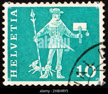 SWITZERLAND - CIRCA 1960: a stamp printed in the Switzerland shows Messenger, Schwyz, circa 1960 Stock Photo