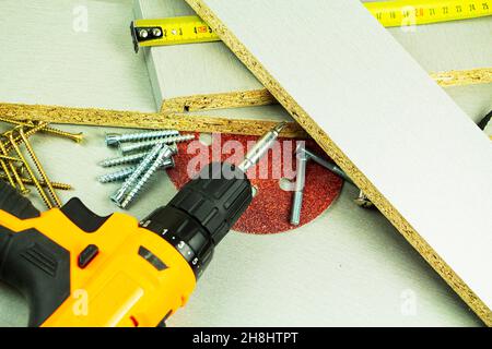 furniture assembly tools, screws, chipboard screwdriver ruler sandpaper Stock Photo