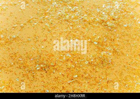 Beautiful festive white background with golden confetti. Flat lay, top view. Stock Photo