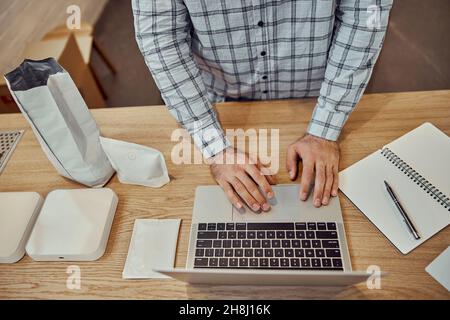 Male worker using modern laptop in cafe Stock Photo