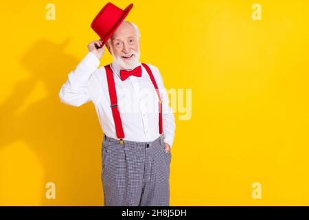 Photo of funky old man dress new cap wear tie shirt suspenders pants isolated on yellow background Stock Photo