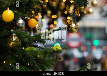London, UK.  30 November 2021. Baubles on Christmas trees outside Harvey Nichols in Knightsbridge on the first day that face coverings are again required in shops following the UK government’s new measures to try to curb the spread of coronavirus following the detection of the Omicron variant.  Credit: Stephen Chung / Alamy Live News Stock Photo