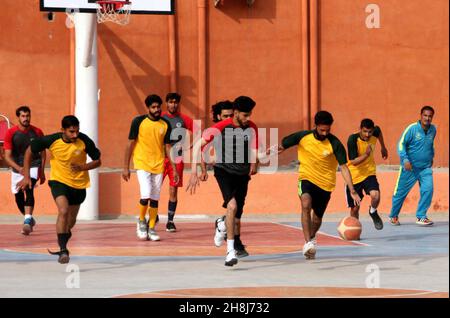 Hyderabad, Pakistan, November 30, 2021. Players are in action during the basket ball match during the Under-21 Games held at Qayyum Sports Complex in Peshawar on Tuesday, November 30, 2021. Stock Photo