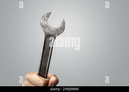 Large wrench tool held by a hand Stock Photo