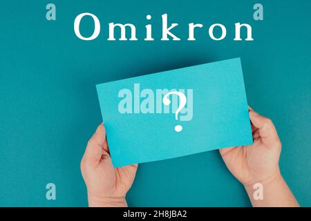 The german word for omicron is standing on a paper, new covid-19 variant from south africa, pandemic Stock Photo
