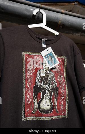 T-shirts designed by British rock musician Jon Langford for sale in a store in Chimayo, New Mexico. Langford is a founding member of the Mekons. Stock Photo