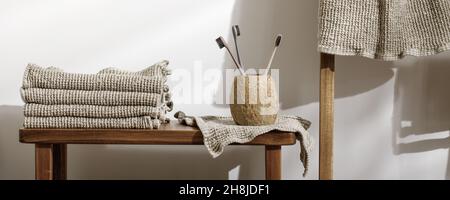Organic waffle linen towels, three toothbrushes in modern bathroom interior. Daily body care, spa and wellness zero waste bathroom concept Stock Photo