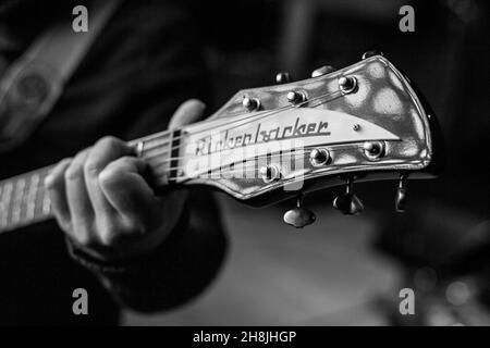 Male  hands playing Rickenbacker electric guitar Stock Photo