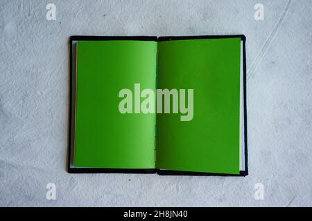 Top view open agenda for writing. Open life diary. open book with colored pages. Intense green Stock Photo
