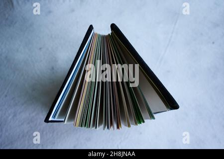 Top view of a folder portfolio with colorful paper sheets isolated on a white background Stock Photo