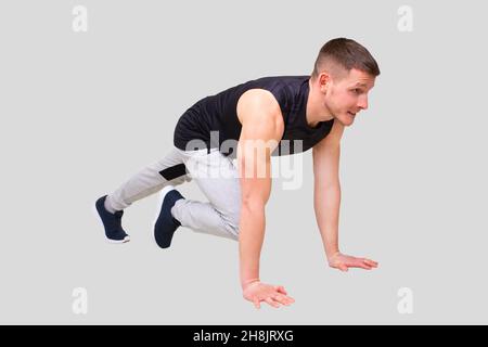 Sport man Standing in Plank Doing ABS Exersice. Sportsman Plank Exercise Stock Photo