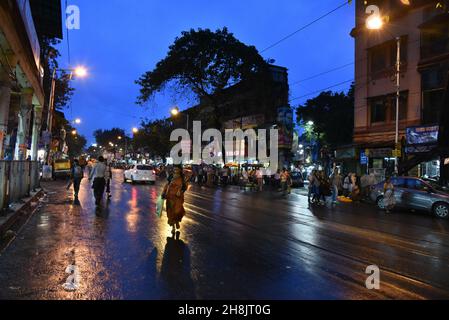 Streets at night in Kolkata. Kolkata (formerly Calcutta) is the capital of India's West Bengal state. Founded as an East India Company trading post, it was India's capital under the British Raj from 1773–1911. Today it’s known for its grand colonial architecture, art galleries and cultural festivals. It’s also home to Mother House, headquarters of the Missionaries of Charity, founded by Mother Teresa, whose tomb is on site. Stock Photo