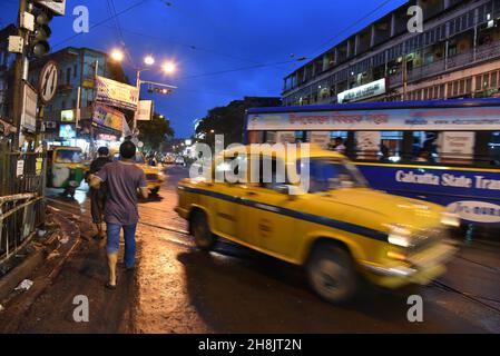 Streets at night in Kolkata. Kolkata (formerly Calcutta) is the capital of India's West Bengal state. Founded as an East India Company trading post, it was India's capital under the British Raj from 1773–1911. Today it’s known for its grand colonial architecture, art galleries and cultural festivals. It’s also home to Mother House, headquarters of the Missionaries of Charity, founded by Mother Teresa, whose tomb is on site. Stock Photo