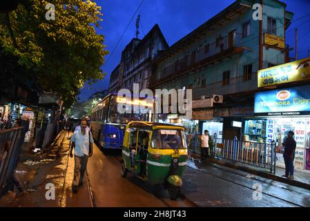 Streets at night in Kolkata. Kolkata (formerly Calcutta) is the capital of India's West Bengal state. Founded as an East India Company trading post, it was India's capital under the British Raj from 1773–1911. Today it’s known for its grand colonial architecture, art galleries and cultural festivals. It’s also home to Mother House, headquarters of the Missionaries of Charity, founded by Mother Teresa, whose tomb is on site. Stock Photo