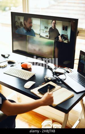 Businesswoman working from home, using multiple screens Stock Photo