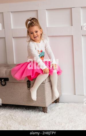 Cute little girl posing in a costume in her room. Little fashion model concept Stock Photo