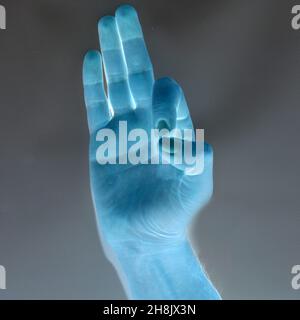 Letter F in American Sign Language (ASL), negative photo, finger spelling over black background Stock Photo