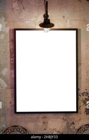 Vertical shot of an empty frame hanging on the wall Stock Photo