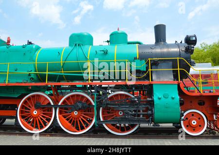 Old steam locomotive 1935-1957 Green with red wheels. Stock Photo