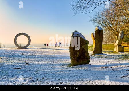 Heavens Gate with snow at sunset, a popular viewpoint with stone sculptures by Paul Norris and views looking down at Longleat House and estate Stock Photo