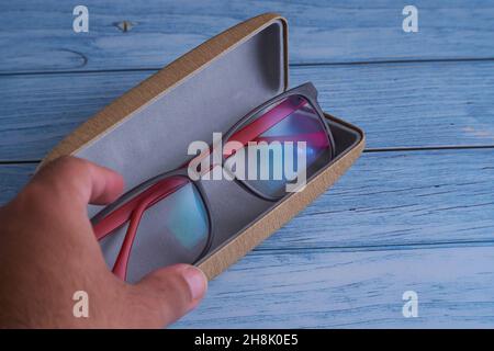 close-up detail of a hand holding his optical glasses Stock Photo
