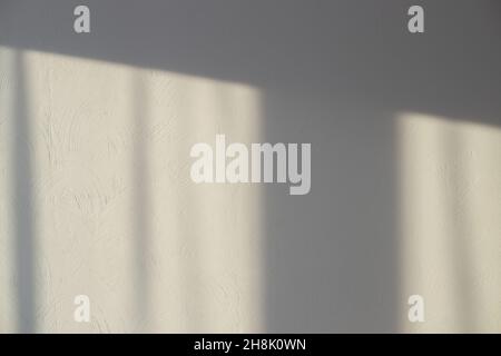 Window shade on a gray wall with decorative plaster. Textured background, template with copy space. Stock Photo