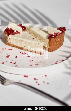 Sliced Cheesecake. Layer of biscuits, mousse based on creamcheese, with raspberry. Healthy dessert. Stock Photo