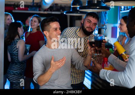 Young people are resting on the corporate event in bar Stock Photo